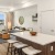 Modern living room at our apartments for rent in Kent, WA, featuring wood grain floor paneling and a kitchen island.