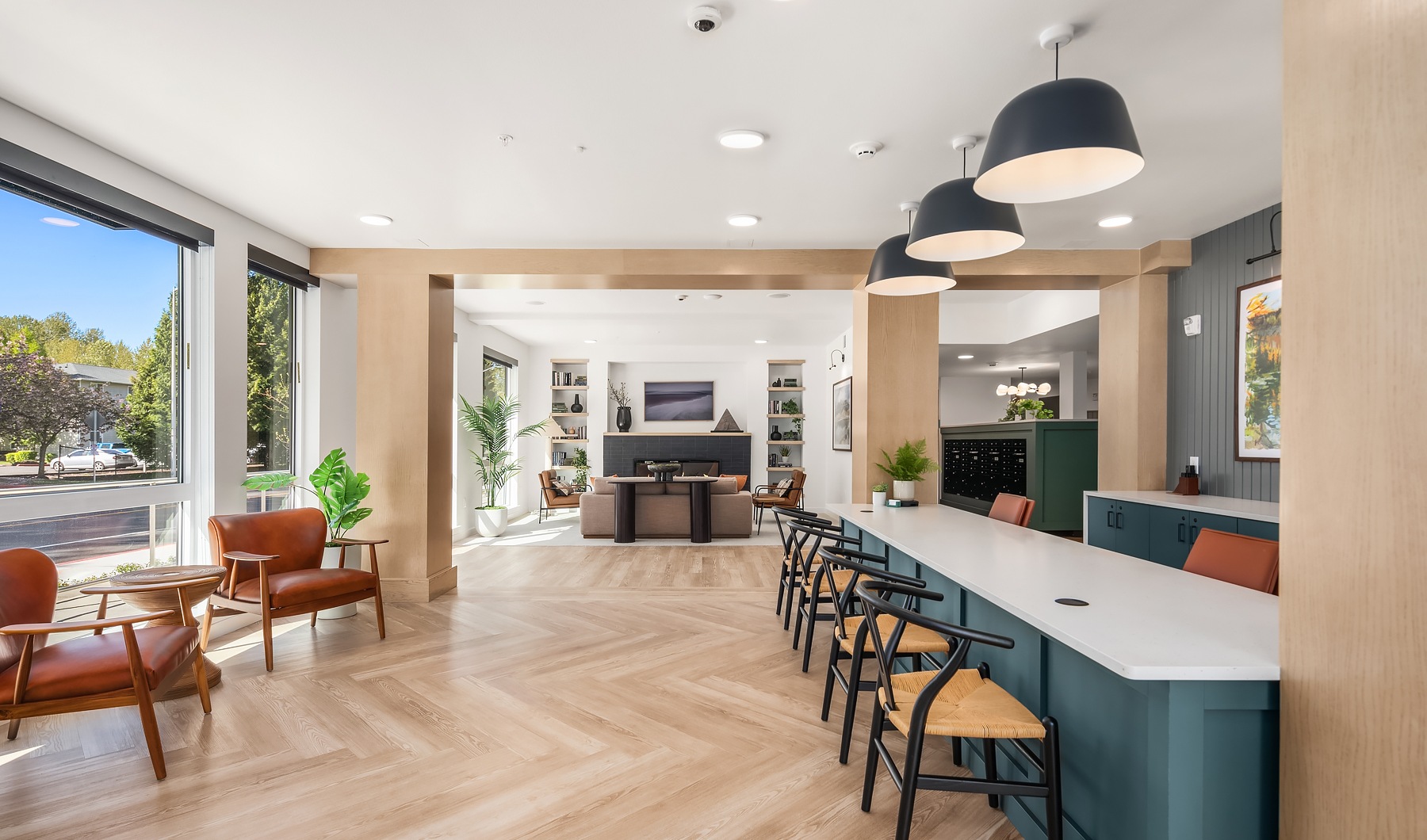 Settle into comfort at Prose Kent Resident lounge at our apartments for rent in Kent, WA, featuring wood grain floor paneling and counter seating.